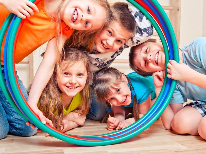Five children look through colorful hoops © anatols/istockphoto